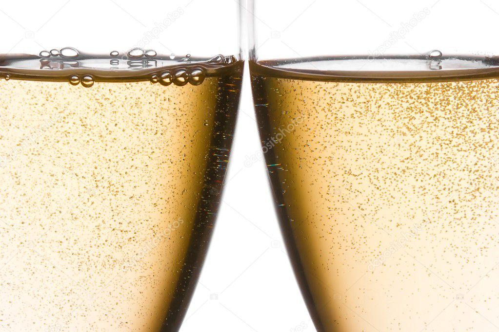 Detail of cheers with two champagne glasses with gold bubbles
