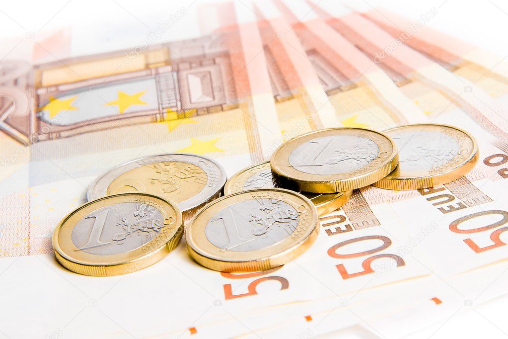 Euro coins on 50-euro banknotes