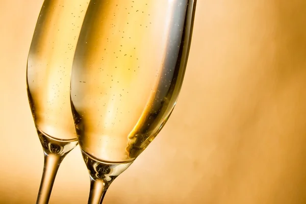 Flutes of champagne with golden bubbles and space for text — Stock Photo, Image