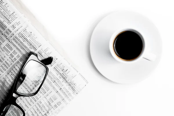 Coffee near financial newspaper and glasses — Stock Photo, Image