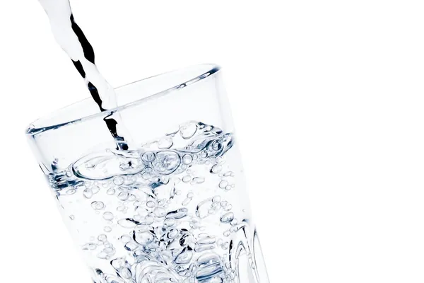 Filling a glass with pure water with bubbles and space for text — Stock Photo, Image