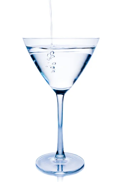 Filling a white cocktail in a glass with blue reflections — Stock Photo, Image