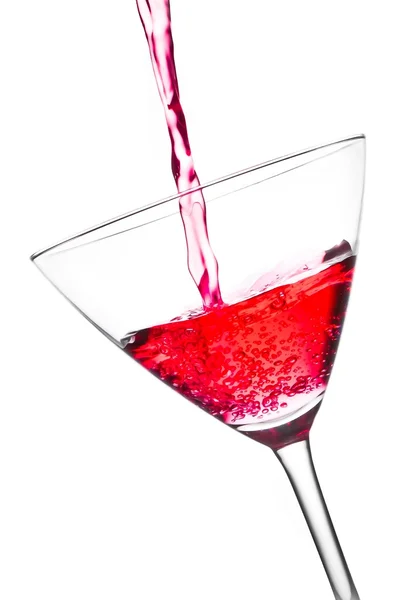 Filling a glass with red cocktail tilted and bubbles — Stock Photo, Image