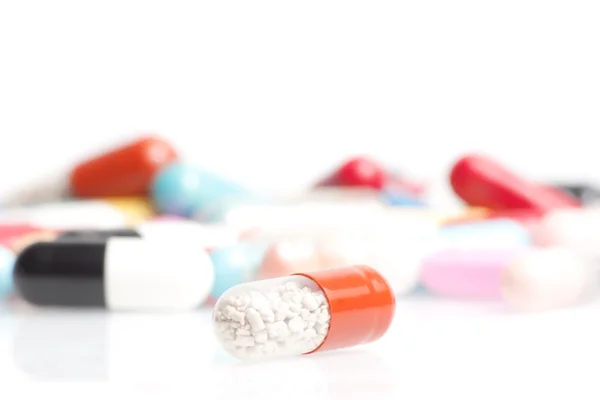 One medical pill in front of a lot of medical pills in laboratory — Stock Photo, Image