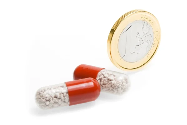 Euromünze und medizinische Tabletten — Stockfoto