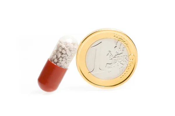 Une pièce en euros et une pilule médicale — Photo