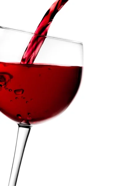 Red wine pouring into half glass tilted with space for text — Stock Photo, Image