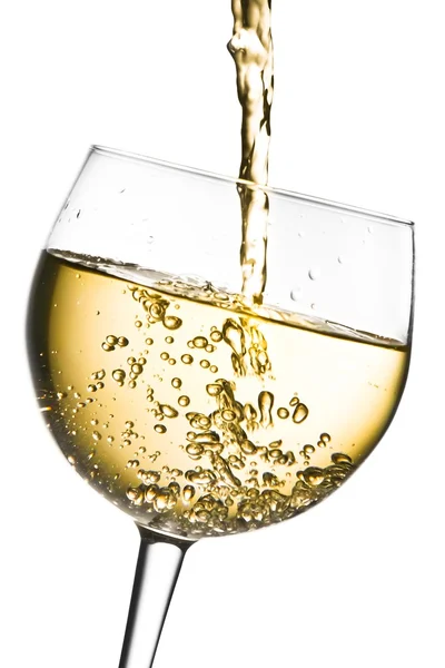 White wine pouring into glass tilted with space for text Royalty Free Stock Photos