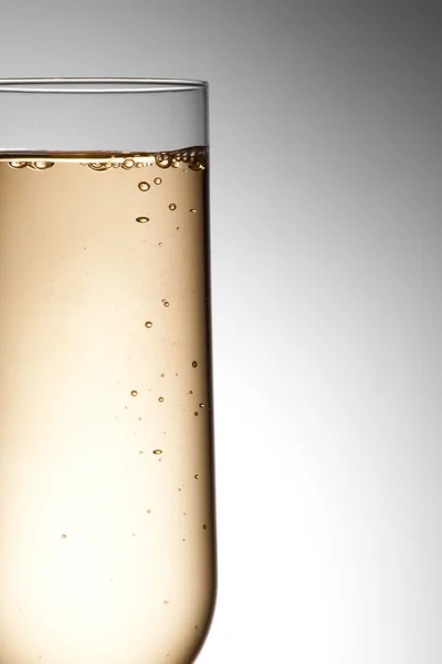Half flute glass of champagne with bubbles — Stock Photo, Image
