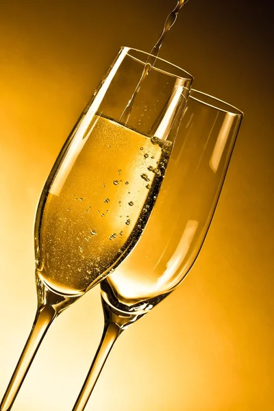 Empty glasses of champagne and one being filled — Stock Photo, Image