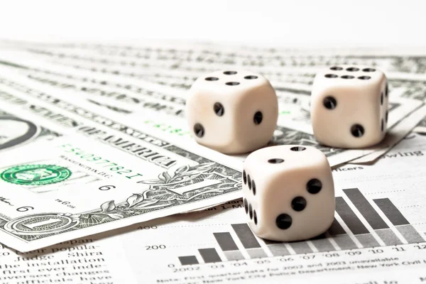 Dice on financial chart near dollars — Stock Photo, Image