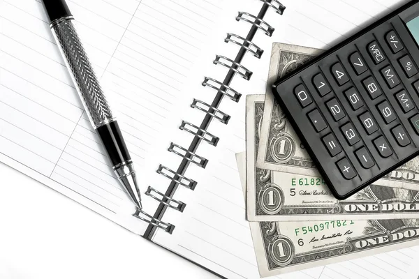 Calculator, dollars and business pen on notebook — Stock Photo, Image