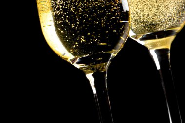 a pair of flutes of champagne tilted with golden bubbles clipart