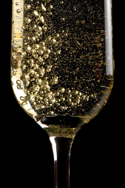 Flute of champagne with golden bubbles — Stock Photo, Image