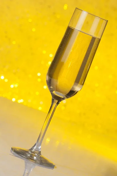 Tilted flute of golden champagne — Stock Photo, Image