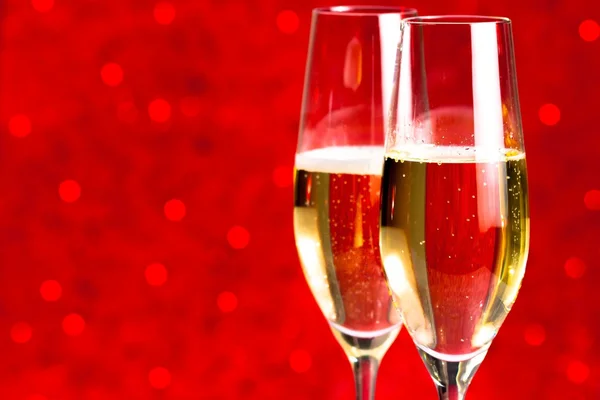 A pair of flutes of champagne red abstract background — Stock Photo, Image