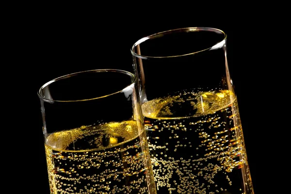 A pair of flutes of champagne with golden bubbles — Stock Photo, Image