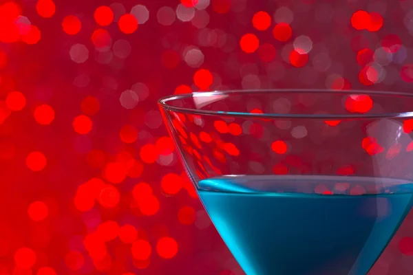 One glass blue cocktail on red background — Stock Photo, Image