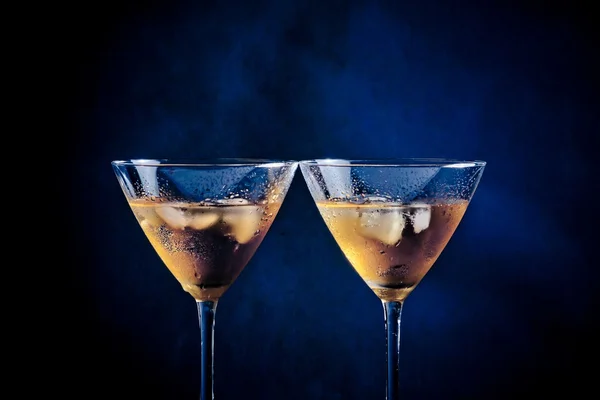 A pair of glasses of fresh cocktail with ice on bar table — Stock Photo, Image