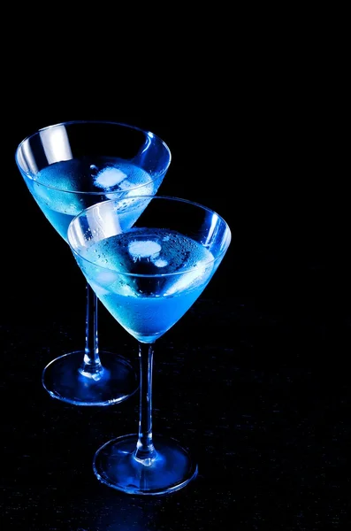 Two glasses of fresh blue cocktail with ice on wood table — Stock Photo, Image