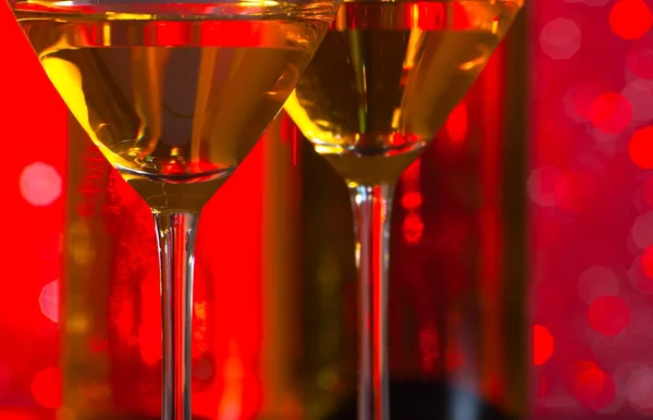 Particular of glasses of cocktail on bar table in front of bottles — Stock Photo, Image