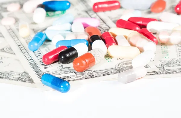 Colorful pills on american dollar — Stock Photo, Image