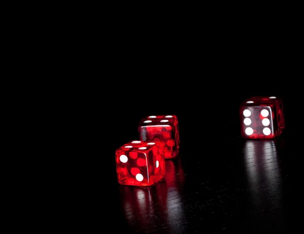 Three red dice on old wood black table with space for text — Stock Photo, Image