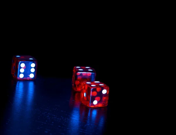 three red dice on old wood black table with space for text