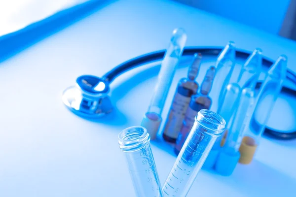 Detail of test tubes in laboratory near stethoscope — Stock Photo, Image