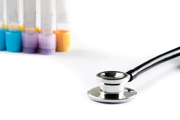 Stethoscope in front of the test tubes in laboratory — Stock Photo, Image