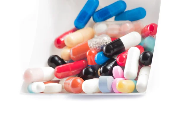 Pílulas coloridas no recipiente — Fotografia de Stock