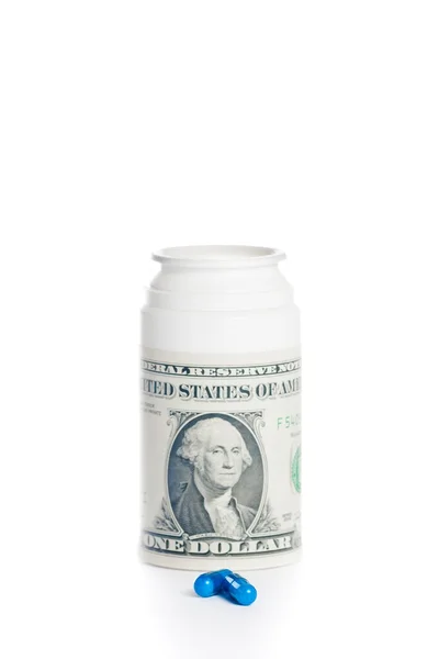 Pills in front of dollar on pills container, cost of medical health care — Stock Photo, Image