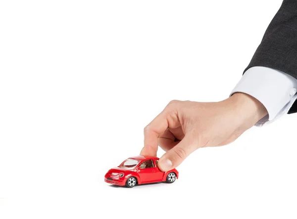 Juguete coche y mano del hombre, concepto de seguro, compra, alquiler, combustible o servicio y gastos de reparación — Foto de Stock