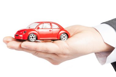 toy car in the hand of business man concept for insurance, buying, renting, fuel or service and repair costs clipart