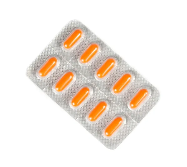 Top of view of orange pills packed in blister isolated — Stock Photo, Image