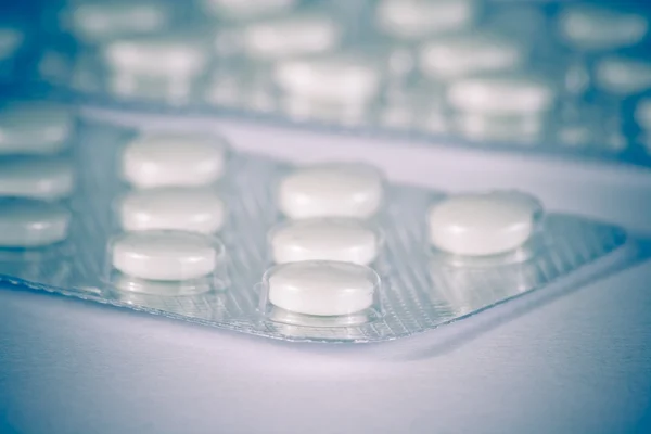 Подробности белые таблетки упакованы в волдырь изолированы — стоковое фото