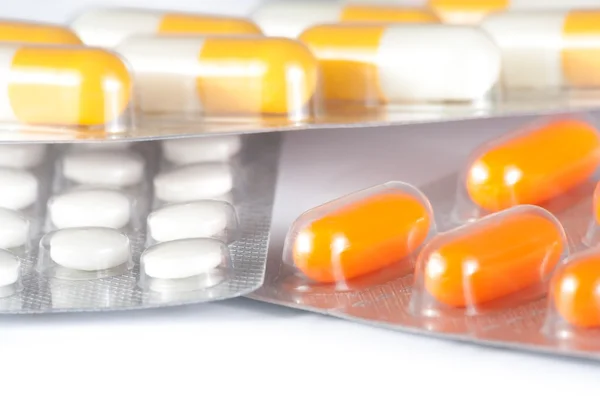 Close up of medicine pills and capsules packed in blisters — Stock Photo, Image