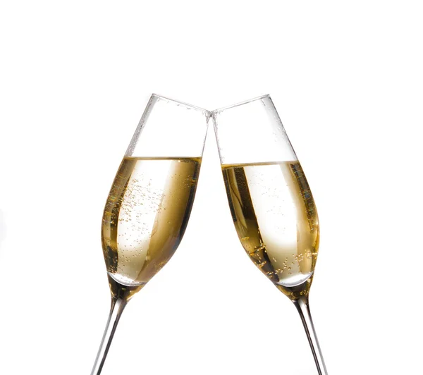 Two champagne flutes with golden bubbles make cheers on white background — Stock Photo, Image