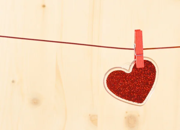 Valentine day series, decorative red heart hanging on wood background — Stock Photo, Image