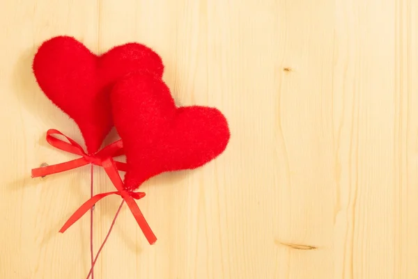 Valentine day series, decorative red hearts hanging on wood background — Stock Photo, Image