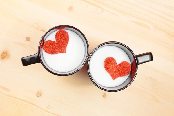 Top of view of cups of milk with decorative heart on wood table, concept of valentine day — Stock Photo, Image