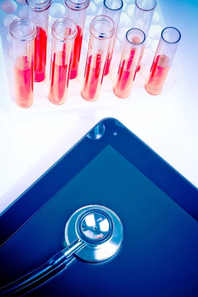 Top of view of medical stethoscope on modern digital tablet pc in laboratory — Stock Photo, Image