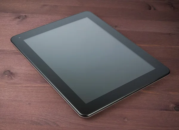 Modern black tablet pc on old wood table — Stock Photo, Image