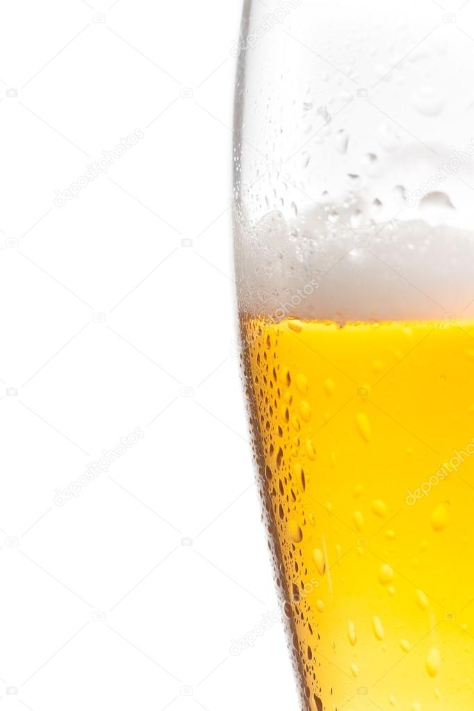 half glass of fresh beer with drops on white background