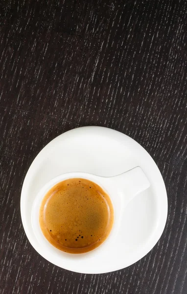 Top of view of great italian coffee in a white cup on black wood table — Stock Photo, Image