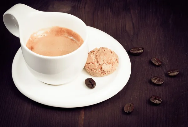 Cup of espresso coffee and biscuit near coffee beans, old style — Stock Photo, Image