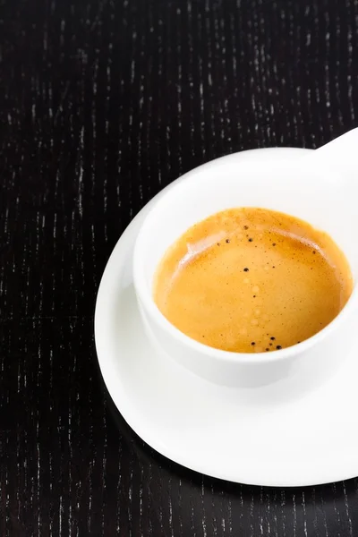 Great italian coffee in a white cup on black wood table — Stock Photo, Image