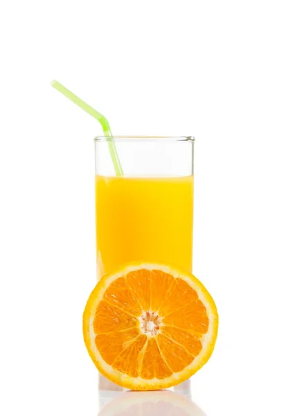 Half orange in front of glass of orange juice with straw on white background — Stock Photo, Image