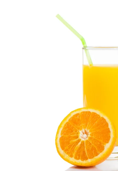 Half orange in front of glass of orange juice with straw on white background — Stock Photo, Image