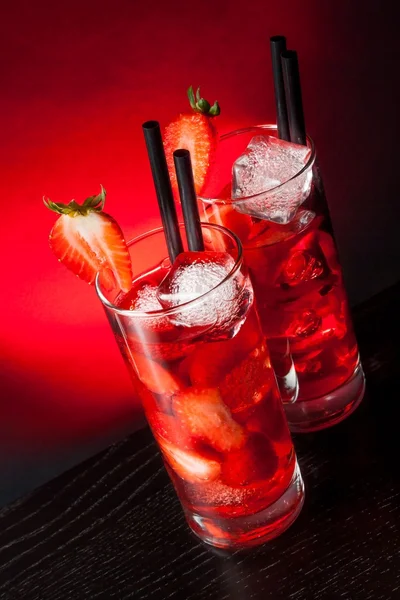 Glasses of strawberry cocktail with ice on wood table — Stock Photo, Image